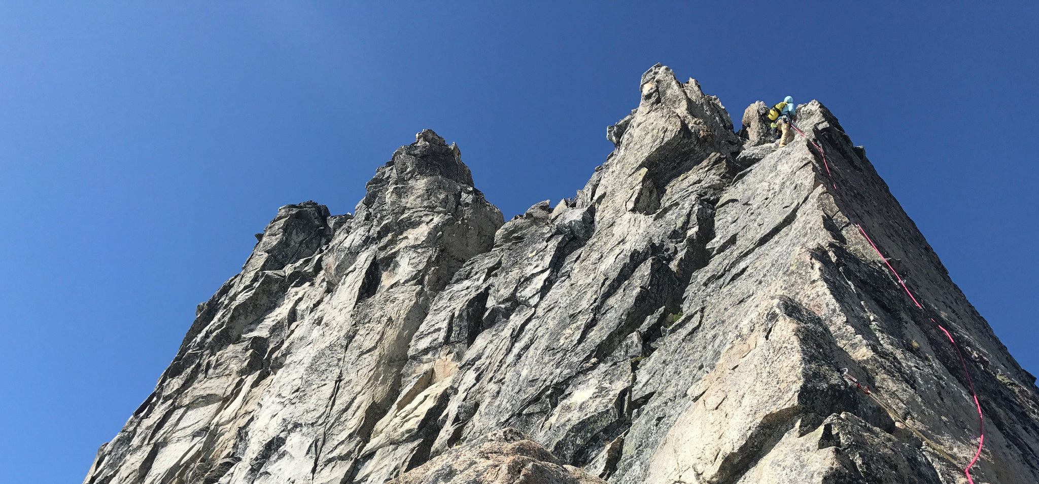 A climber high on Sharkfin Tower, one of the classic climbs in Boston Basin.