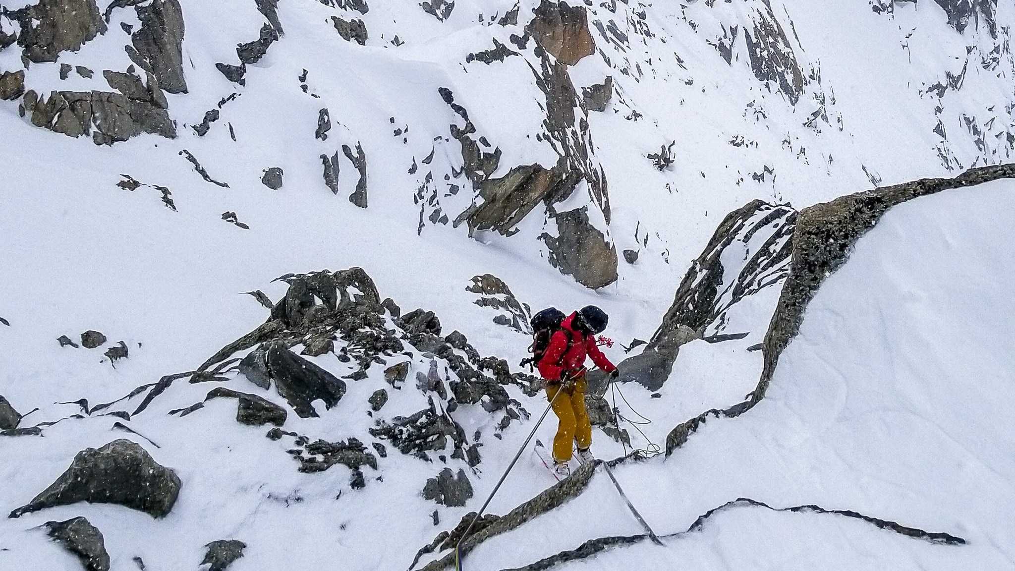 rappelling into the Cosmiques Couloir in Chamonix, French Alps
