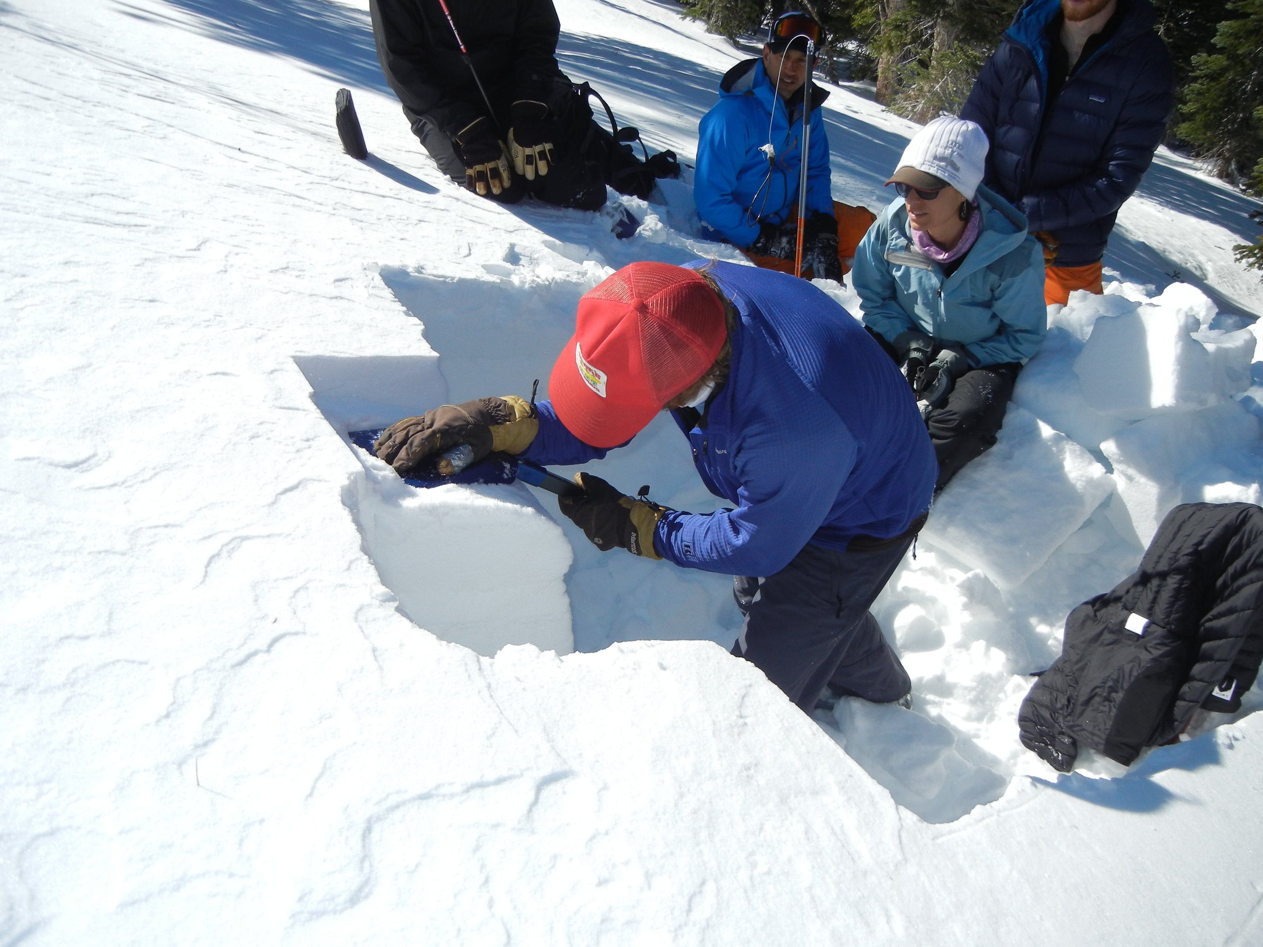 Students learning to perform snow pit shear test during an AIARE 1 Avalanche course.