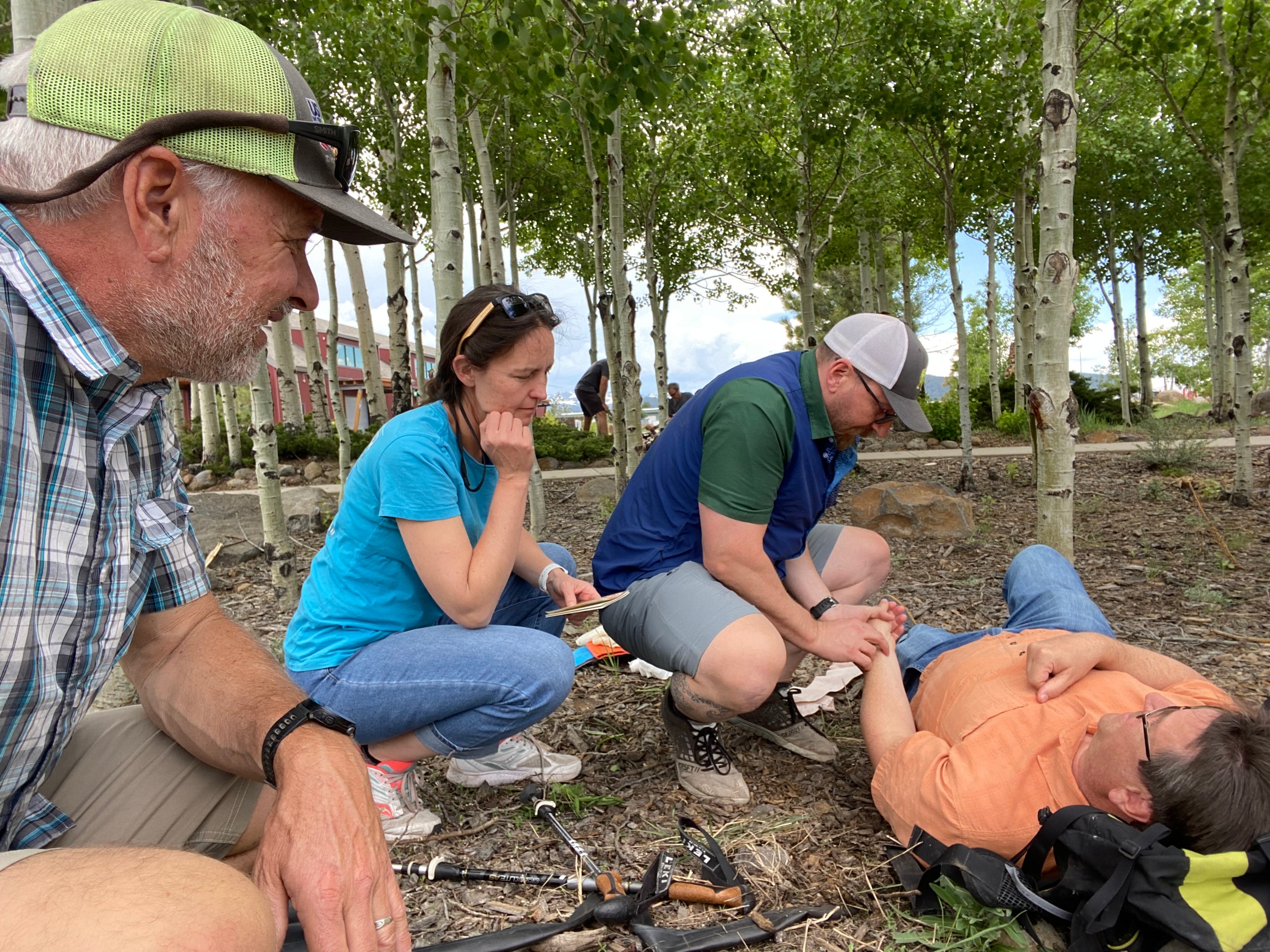 A WFR assessing an injured person on a wilderness First Responder Course