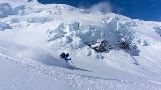 A ski mountaineering guide making powder turns on Mt Baker