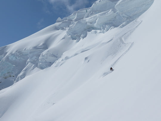 Skier ripping a powder turn at Icefall Lodge in British Columbia