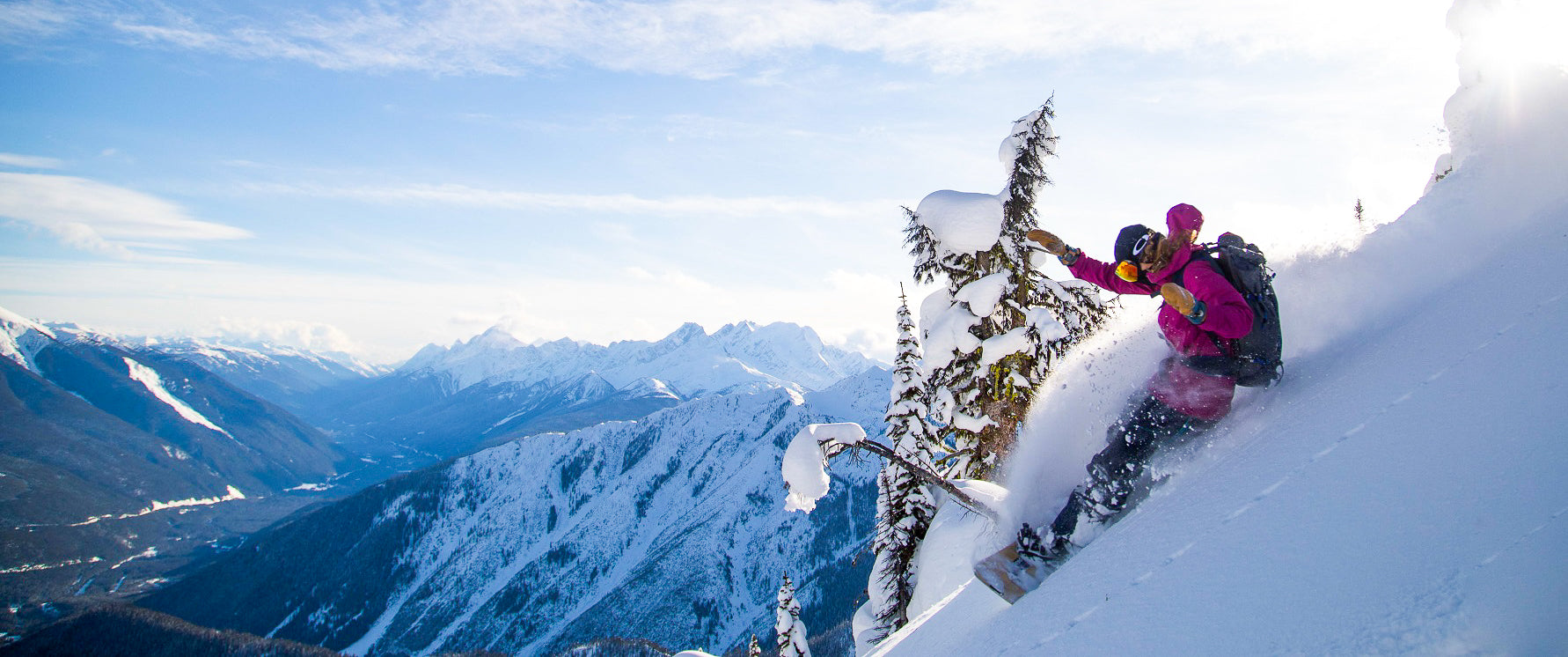 Snowboarder slashing a pow turn during Blackbird Guides Sunrise Lodge BC Ski Week