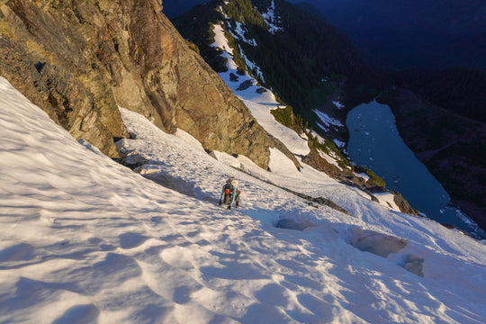 Climber on the North Face of Mt Shuksan above a lake