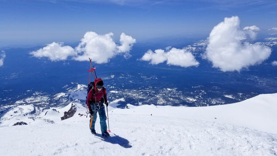 Skier hiking with ice ax on the summit of Mt Shasta