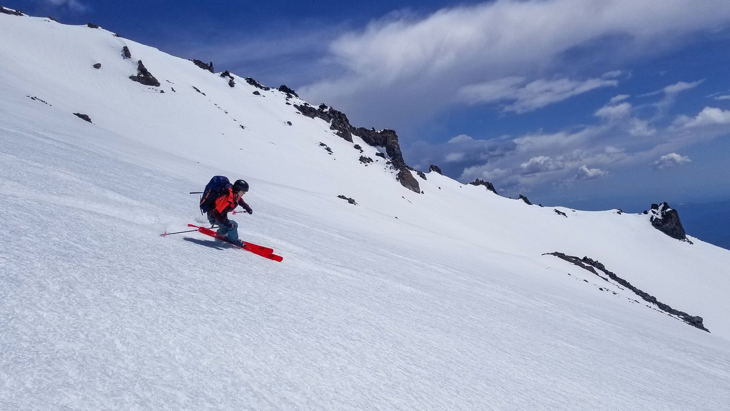 Skier making a turn on Mt Shasta in California during a Blackbird Guides Summit & Ski 3 Day trip