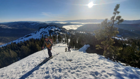 Skier on a ridge above Lake Tahoe during a Blackbird Guides Sugarbowl to Squaw Ski Tour
