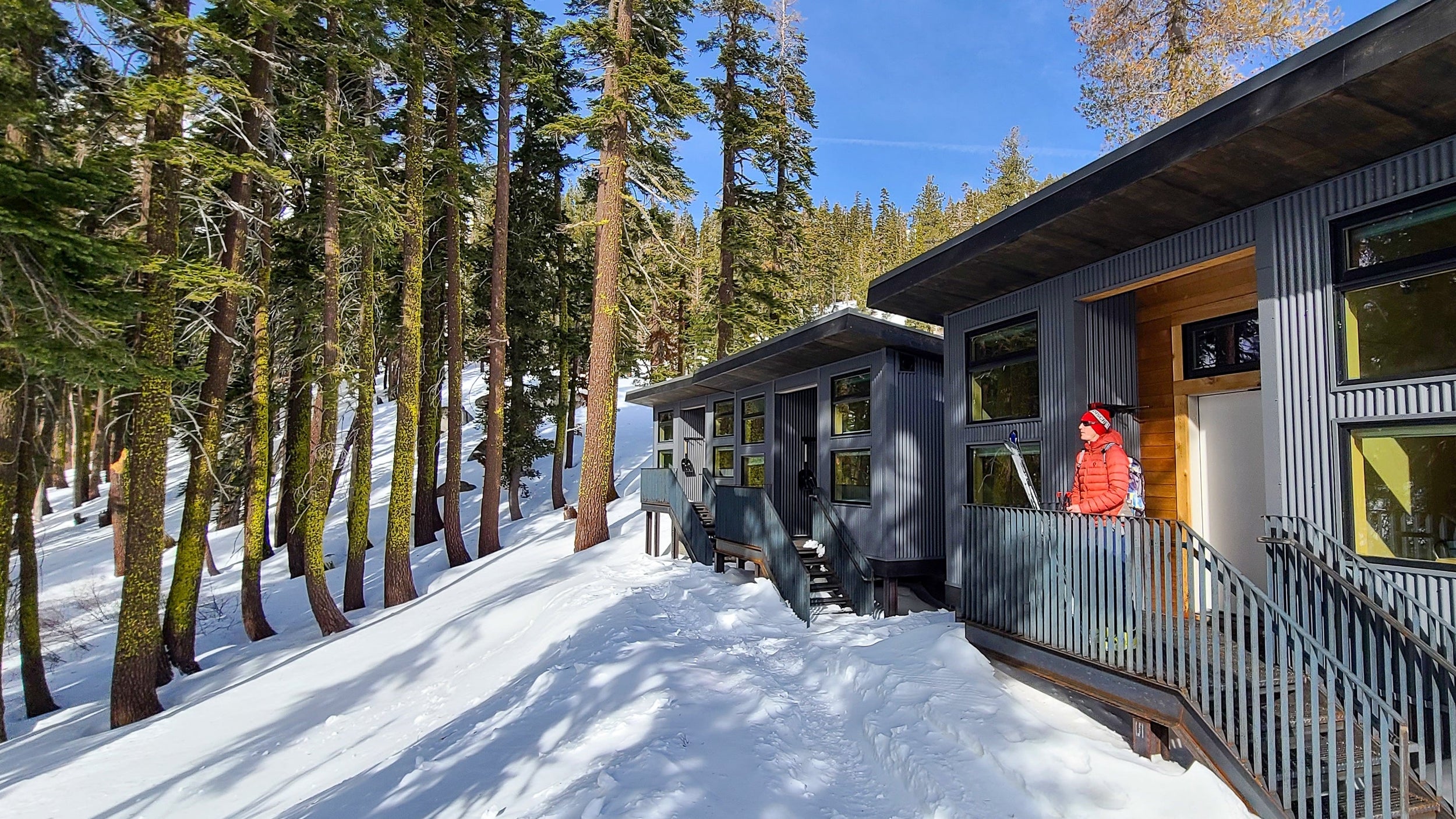 A backcountry skier enjoying the view from the deck of the Morgan Hut, one of the new huts at the Frog Lake Backcountry Hut system.  The amenities make these huts the best huts in the North Lake Tahoe and Truckee area.