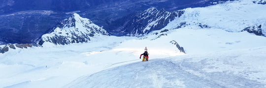 Skier using a rope to climb a steep face during a Blackbird Guides Rope Skills for Skiers and Riders course