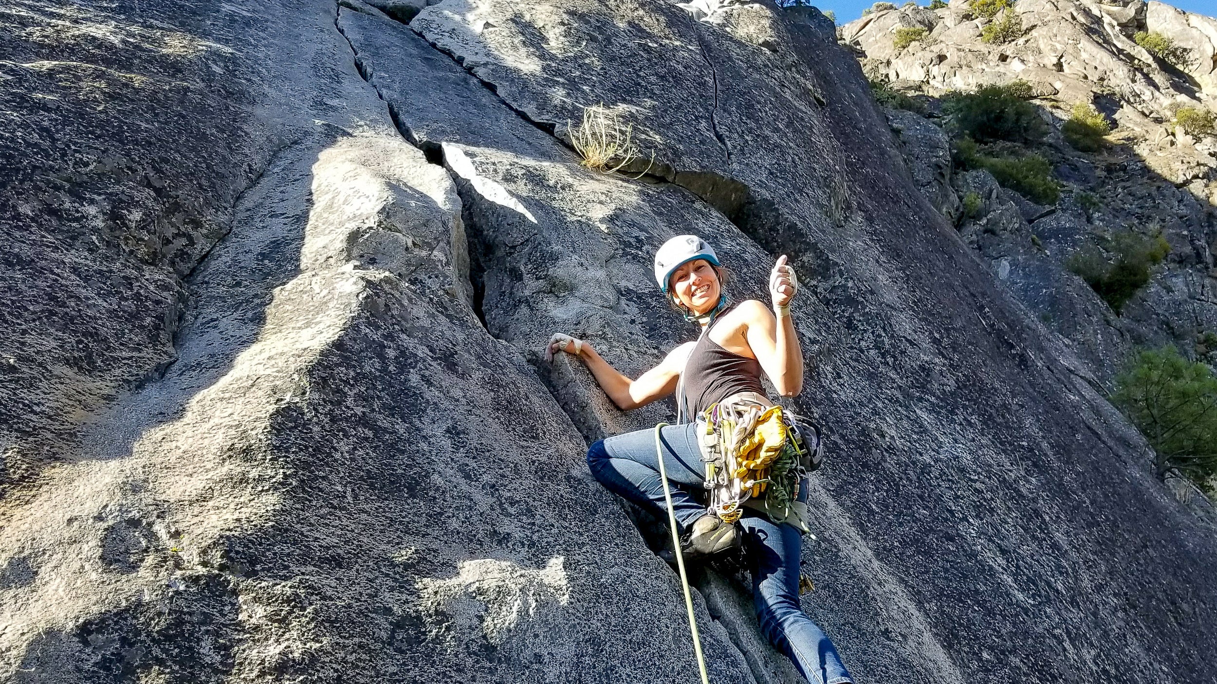 Rock climber on a face in North Lake Tahoe during a Blackbird Guides Rock Climbing Private course