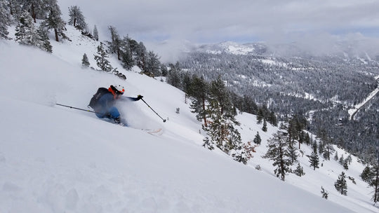 Skier making a powder turn during a Blackbird Guides Private Ski Touring trip in North Lake Tahoe
