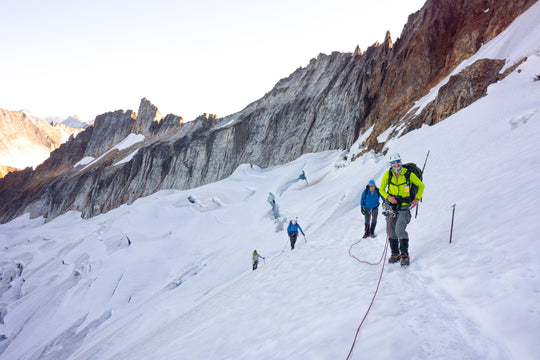Mountaineers climbing with ropes on a glacier in the North Cascades in Washington